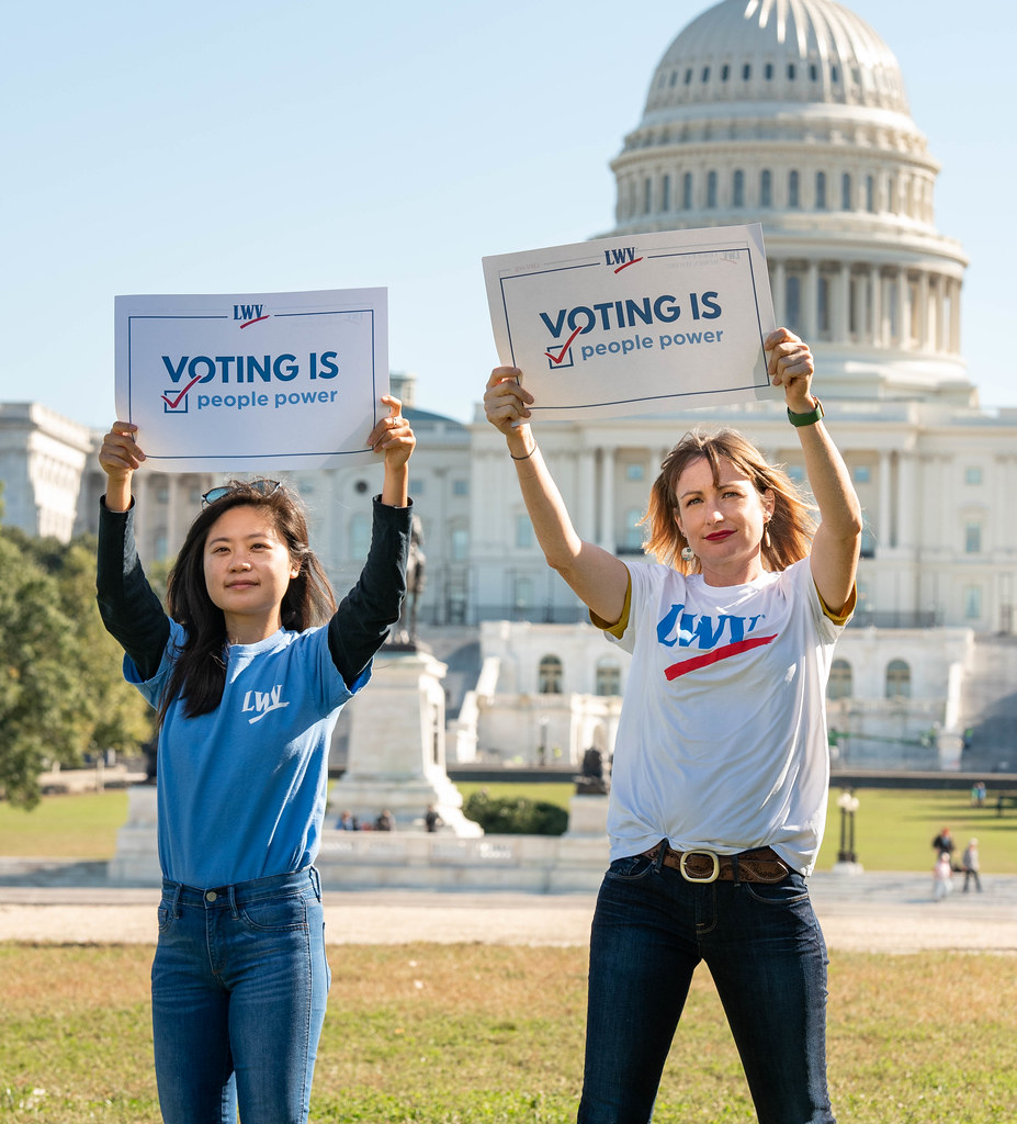 Members at Capitol holding voting rights signs